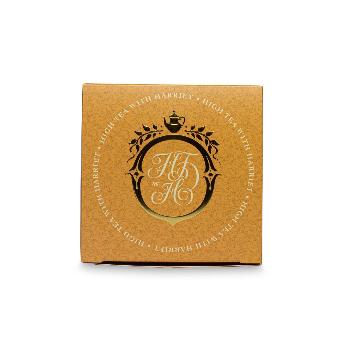 Top view of High Tea with Harriet Fields of Gold box in golden yellow with crest logo
