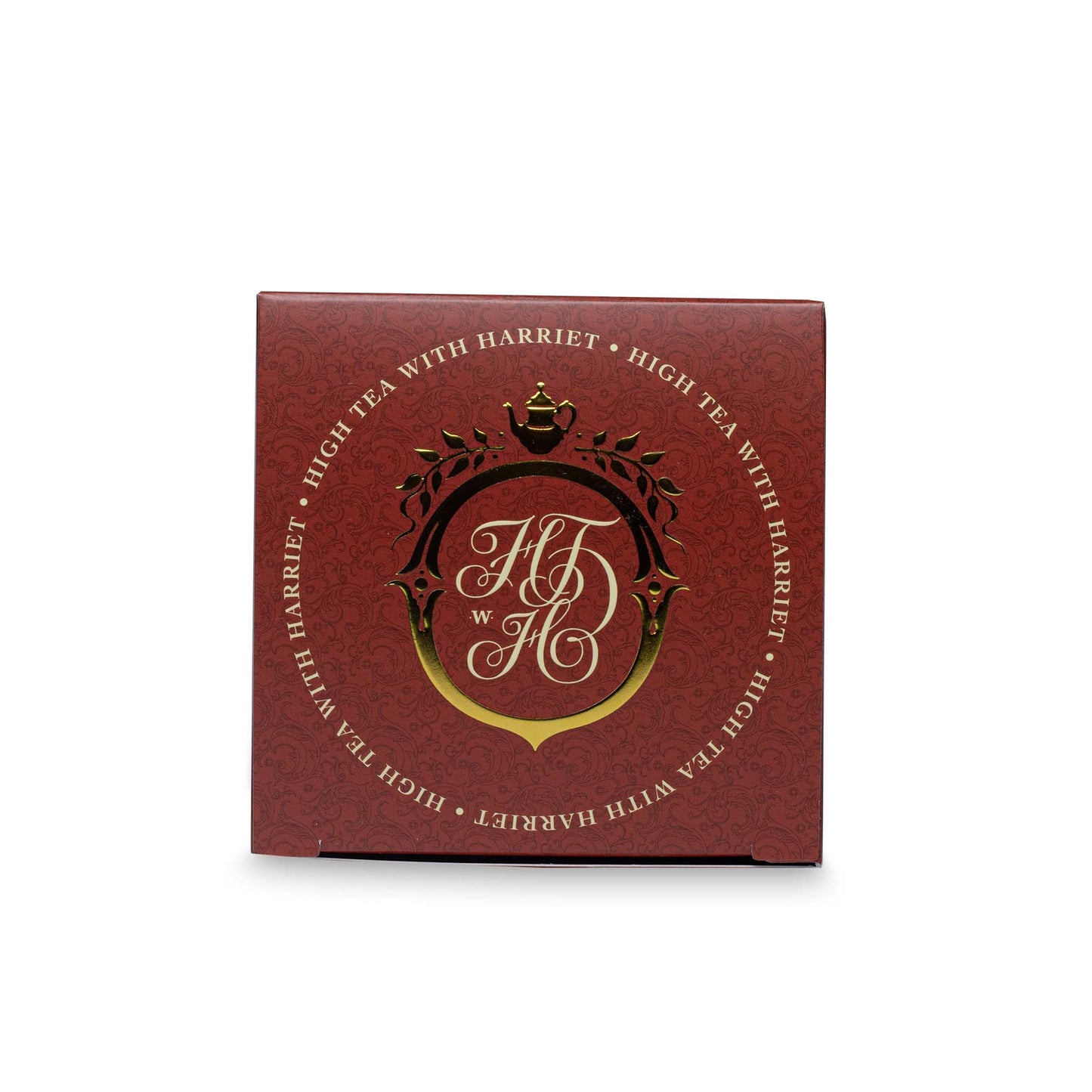 Top view of High Tea with Harriet Ravishing Red tea box in ruby red with gold crest logo