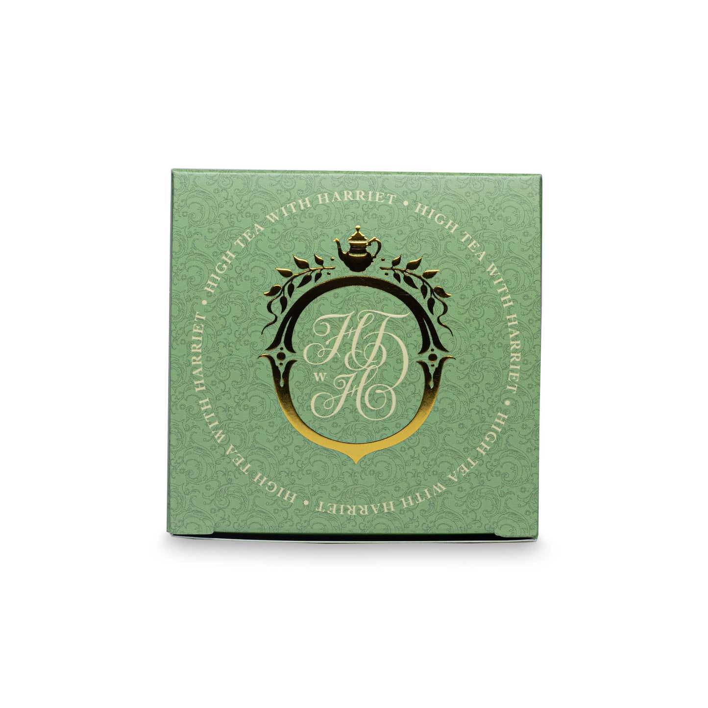 Top view of High Tea with Harriet Rising Sun tea box in pale green with gold crest and botanical design