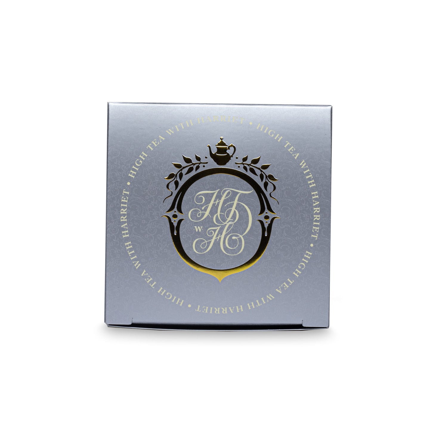 Top view of High Tea with Harriet Wedding Tea box in cream and silver with ornate crest and metallic detailing