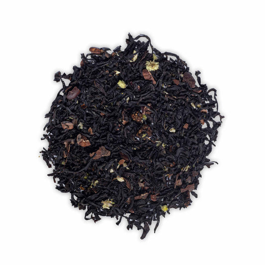 Loose leaf Birthday Tea by High Tea with Harriet featuring black tea, cacao pieces, and dried strawberry on white background