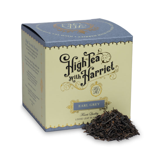 High Tea with Harriet Earl Grey loose leaf black tea in elegant cream and blue box with tea leaves in front
