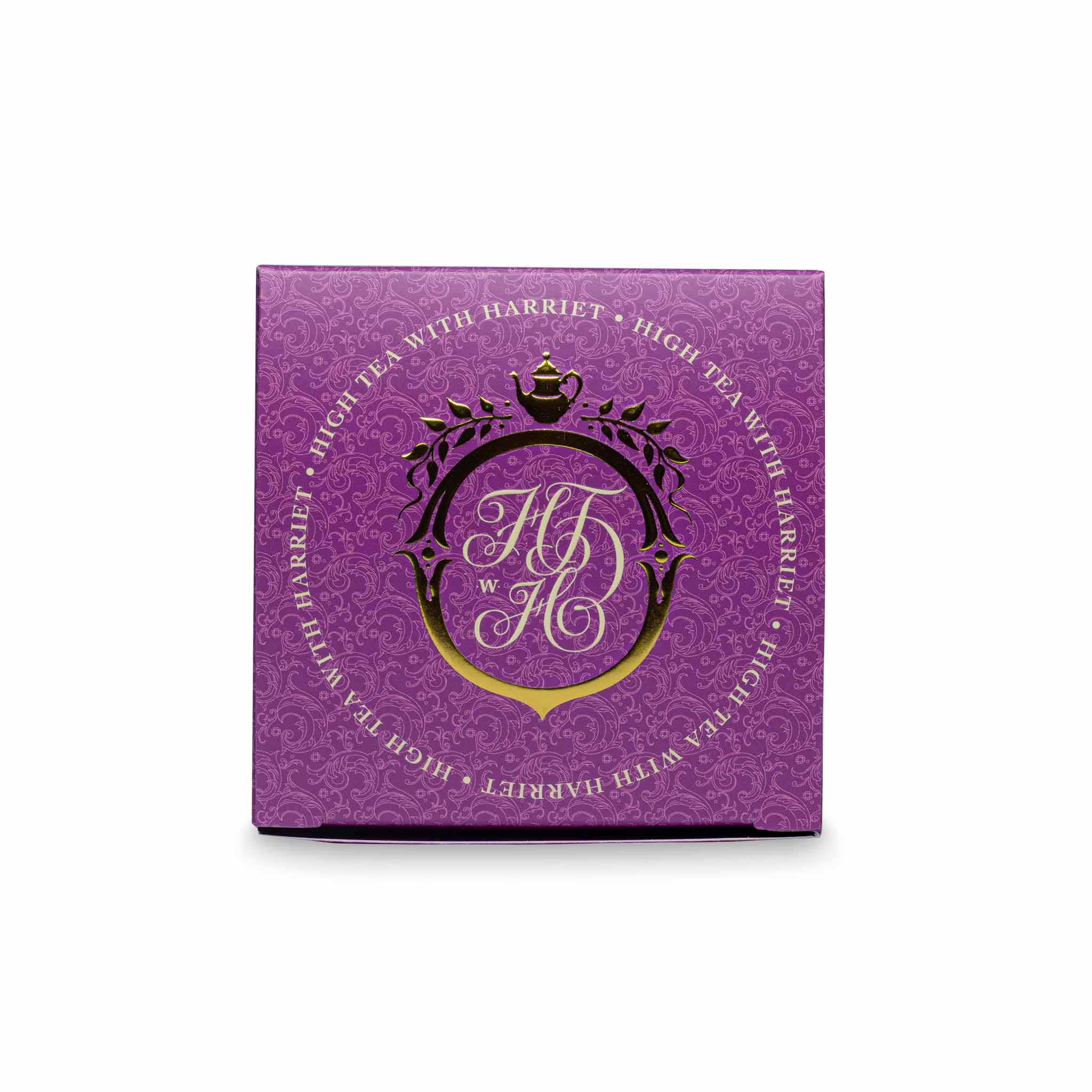 Top view of High Tea with Harriet Monsoon Moon box in purple with crest logo