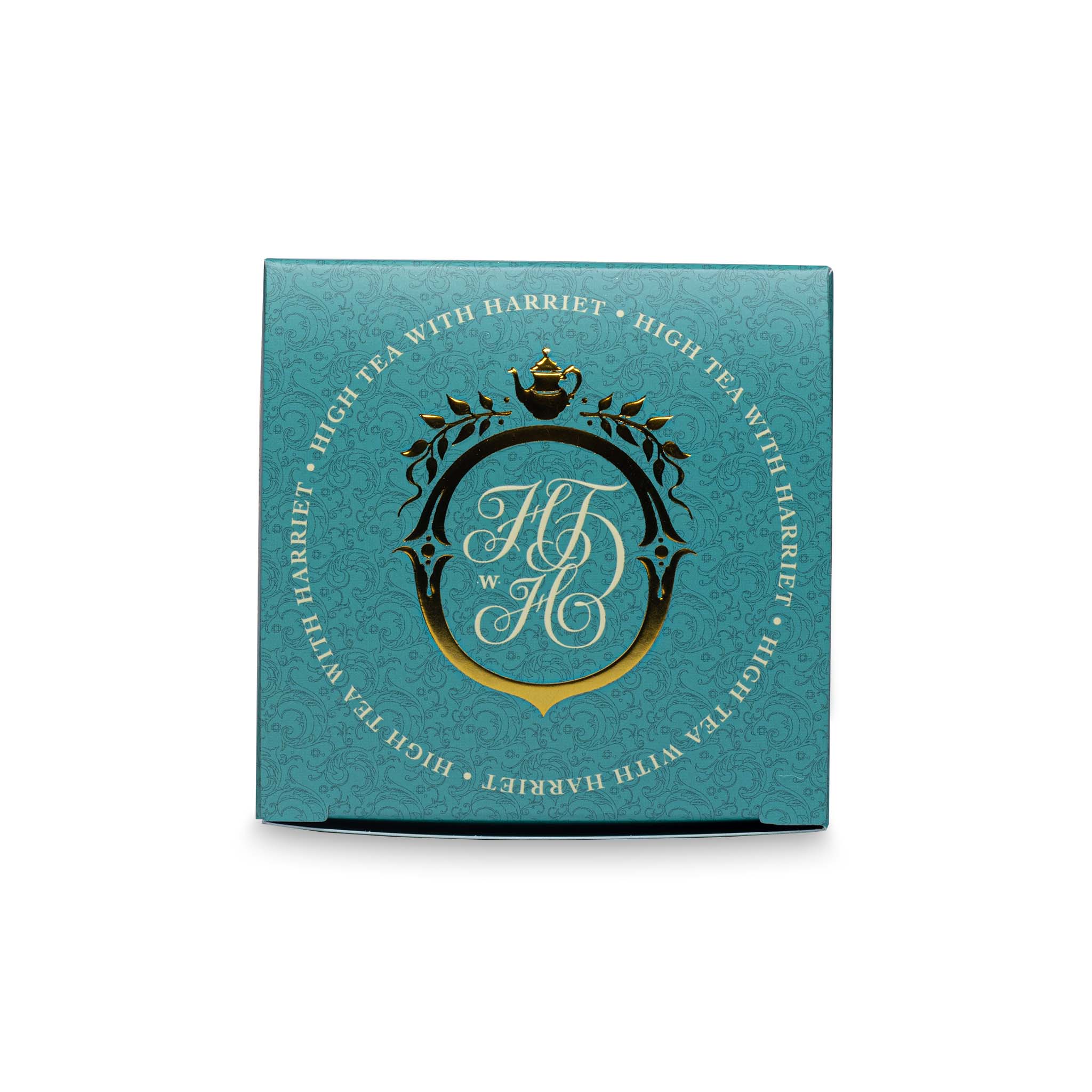Top view of High Tea with Harriet Moroccan Mint tea box in teal and gold with crest logo