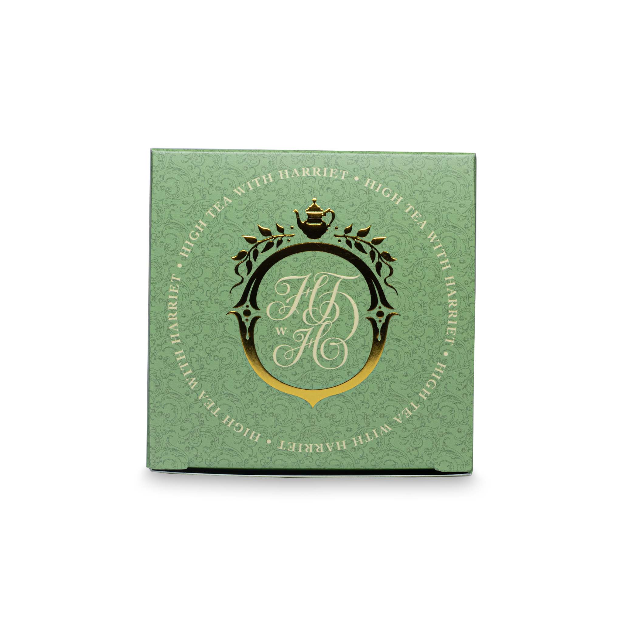 Top view of High Tea with Harriet Rising Sun tea box in pale green with gold crest and botanical design