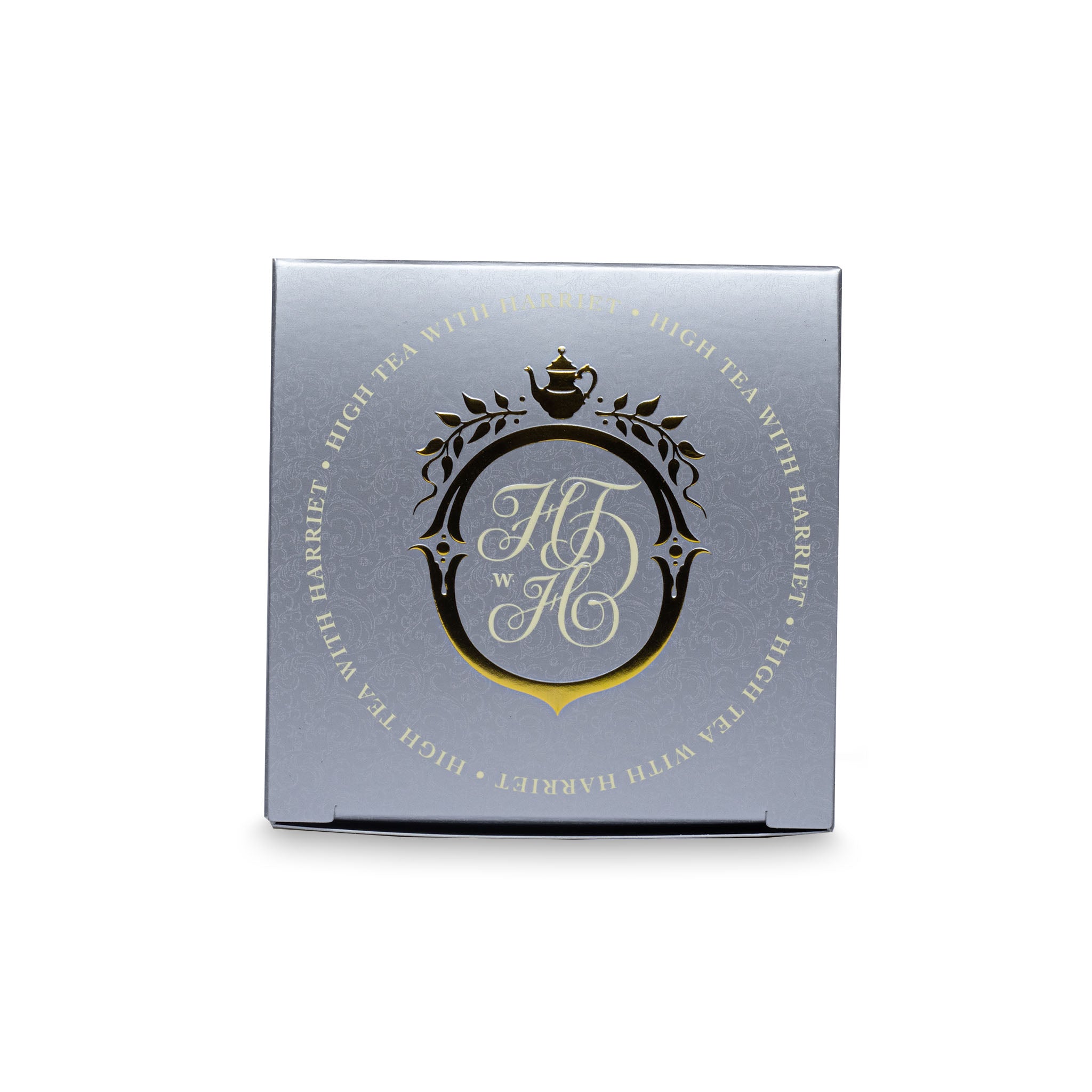 Top view of High Tea with Harriet Wedding Tea box in cream and silver with ornate crest and metallic detailing