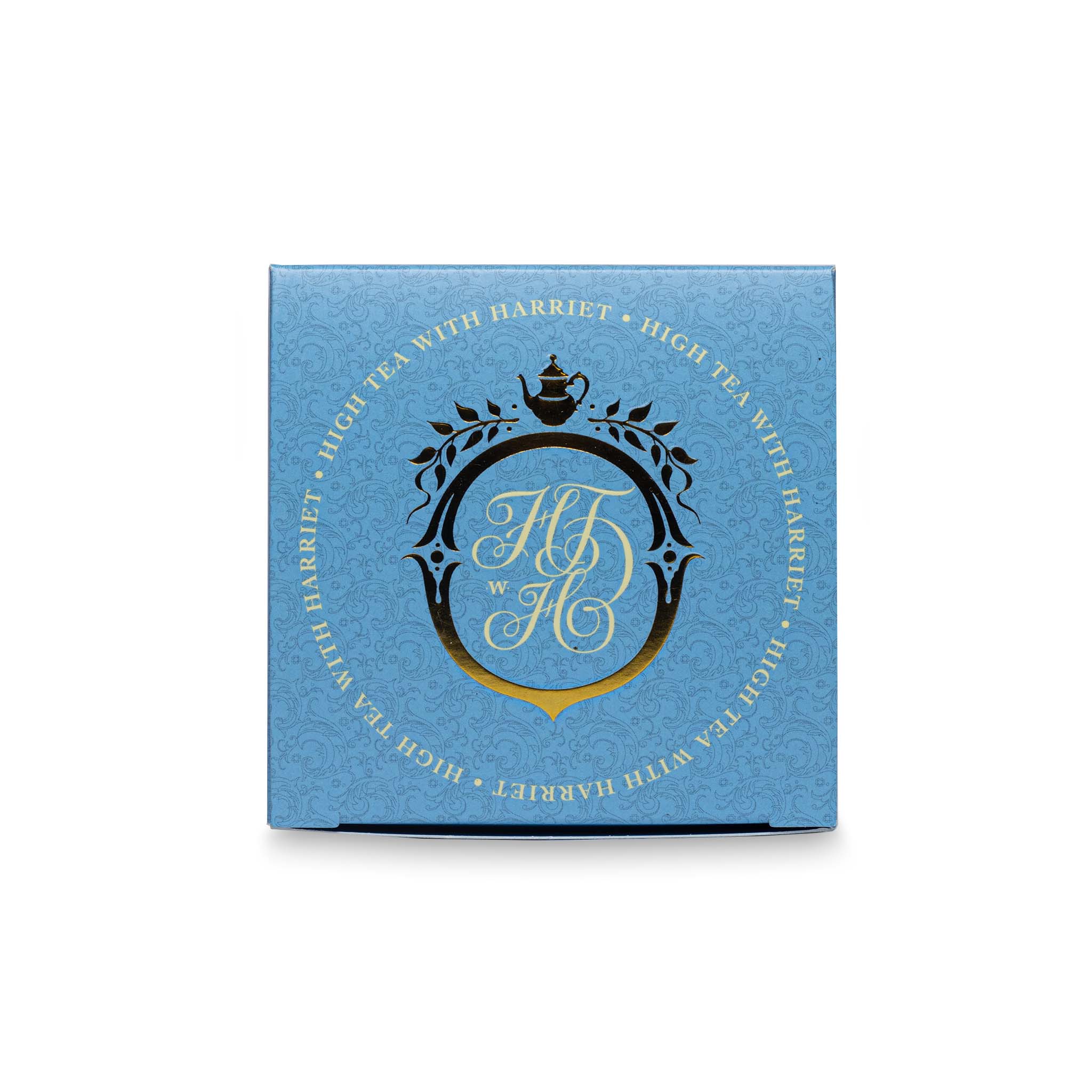 Top view of High Tea with Harriet White Night box in sky blue with gold and black crest and branding