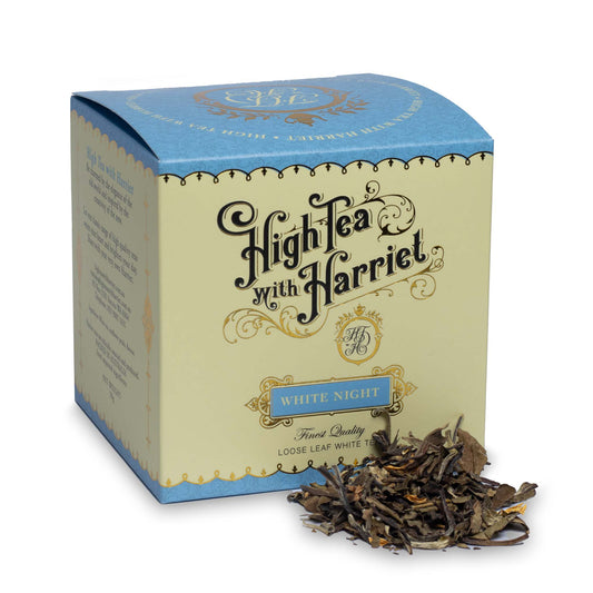 High Tea with Harriet White Night loose leaf white tea in elegant cream and blue box with tea leaves in front