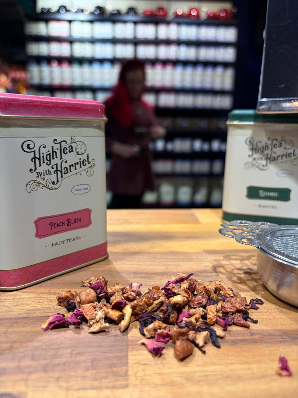 Two tea tins with loose leaf tea on the counter
