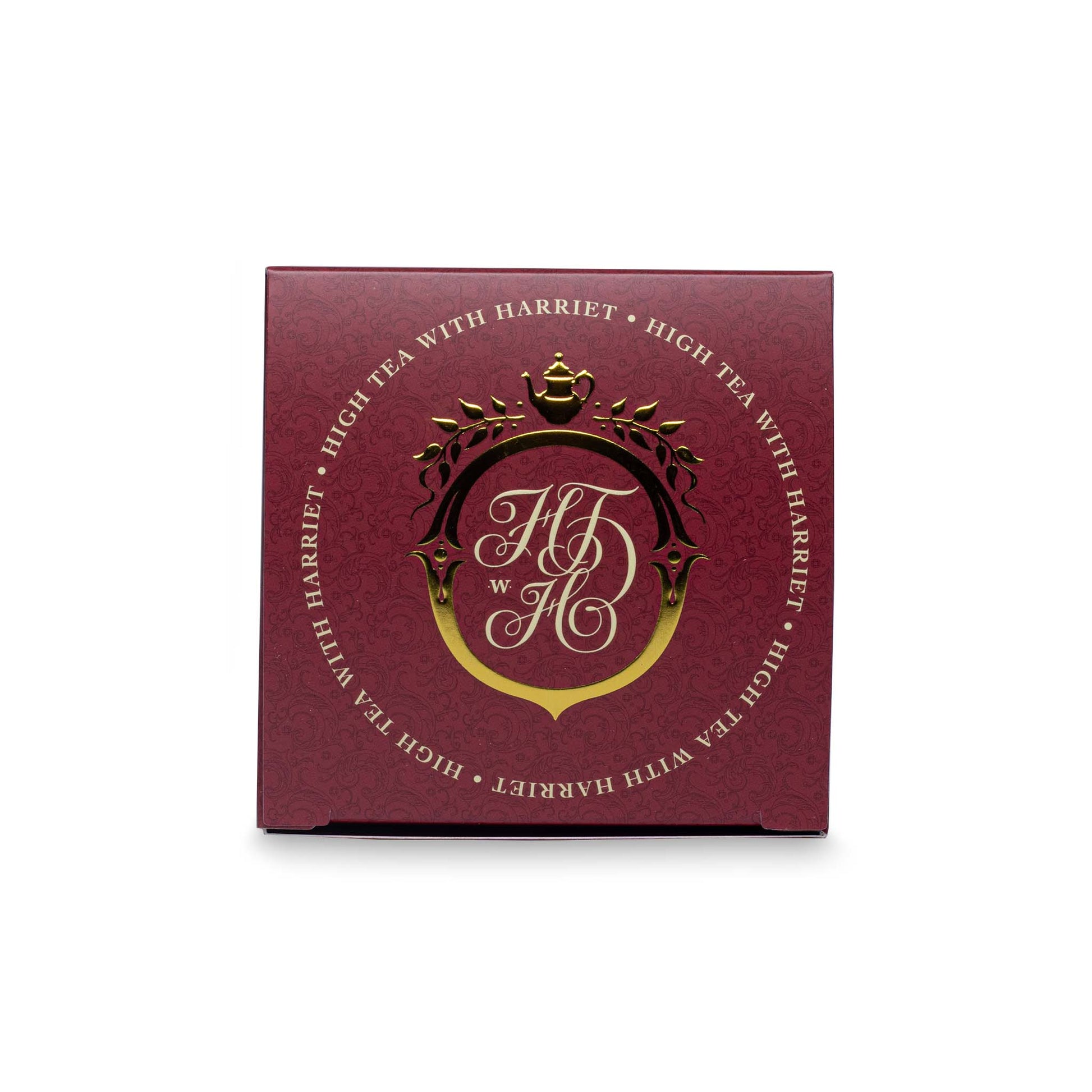 Top view of High Tea with Harriet London Breakfast tea box showing gold crest and branding on burgundy background