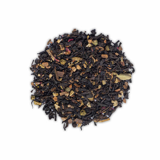 Loose leaf Utterly Charming Chai by High Tea with Harriet with visible spices, rose petals, and tea leaves on white background